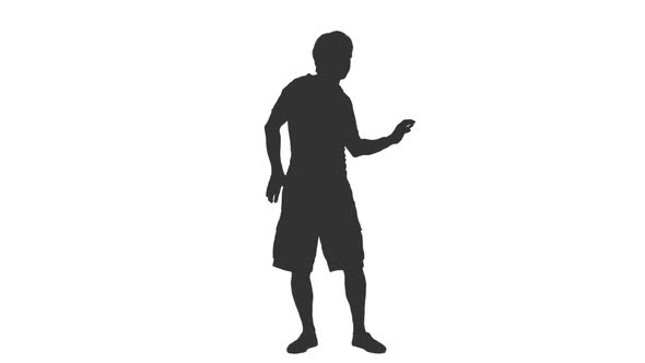 Silhouette of Happy Young Man in Shorts Dancing