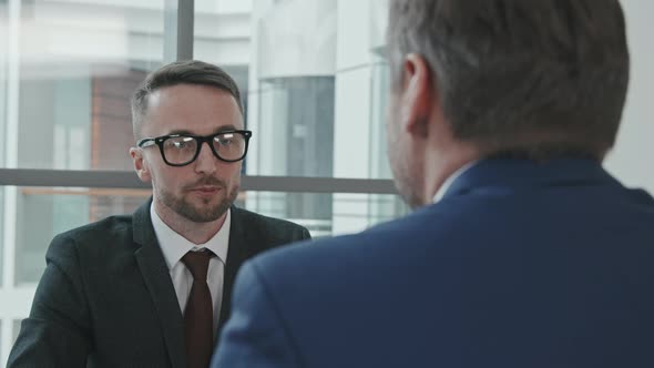 Male Lawyer Consulting Client in Office