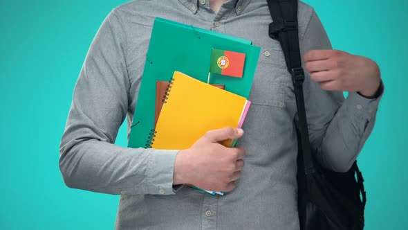 Student Holding Notebooks With Portuguese Flag, International Education Program