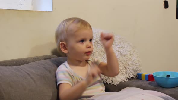 Little girl dancing while watching TV