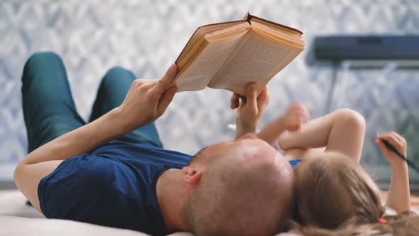 CU Low Angle Dad and Daughter Lie on Floor