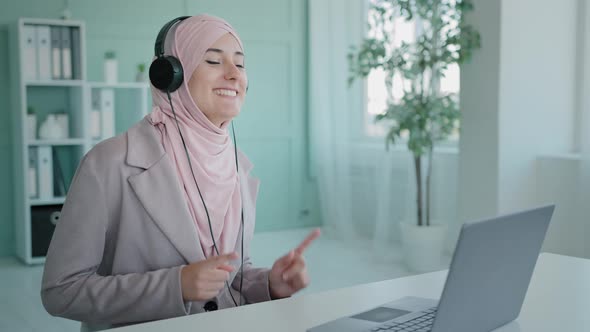 Happy Celebrating Female Muslim Worker in Hijab Islamic Businesswoman Gunny Listening Music with