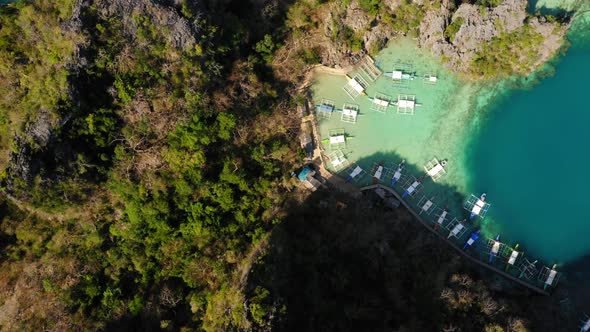 Spider boats parked in Blue lagoon aerial view in Coron, Palawan, Philippines