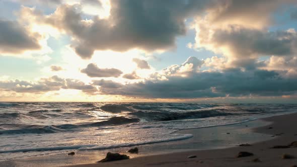 Colorful Sunset on the Baltic Sea, Latvia. Waves Slowly Rolling in on the Beach