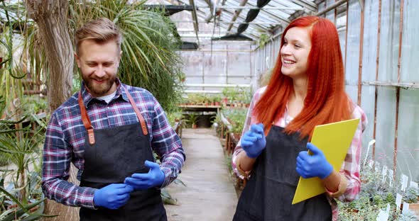 In a Large Family Greenhouse Wife and Husband