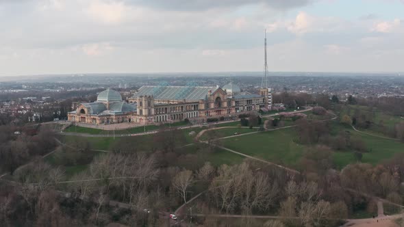 Cinematic circling drone shot around side of alexandra palace and grounds London