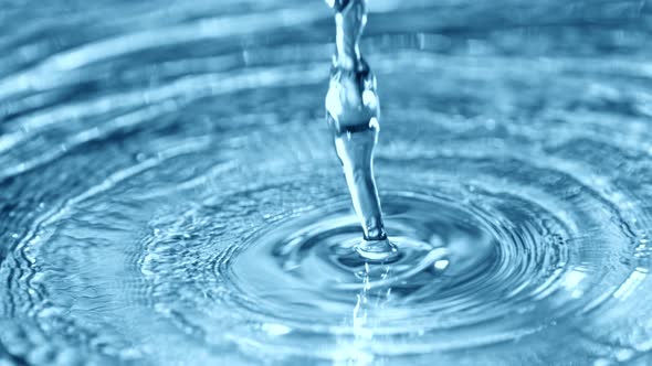 Super Slow Motion Shot of Pouring Water on Light Blue Background at 1000Fps