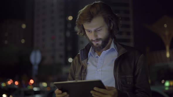 Serious Freelancer Working on Tablet in Night City