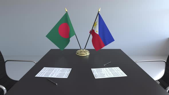 Flags of Bangladesh and the Philippines on the Table