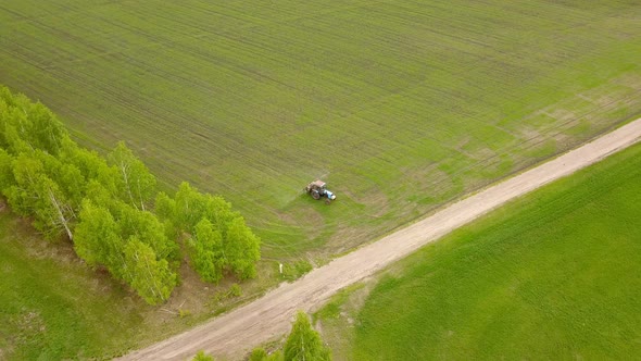 Farm Tractor On A Green Field