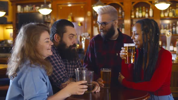 Happy Multiethnic People Drinking Beer at Brewery Bar