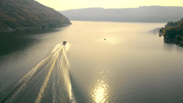 Flight Over a Speedboat Moving in the Riverbed