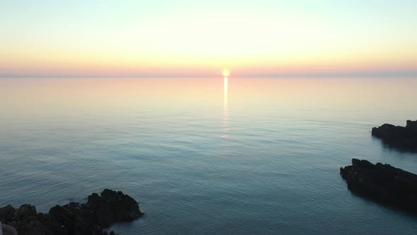 Aerial view of Llanddwyn Lighthouse at sunset on a calm day