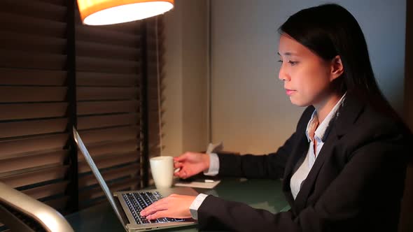 Businesswoman working at night 