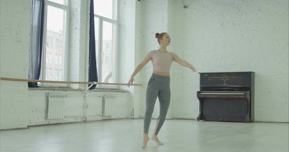 Ballerina Practicing Fouette Turn in Dance Studio