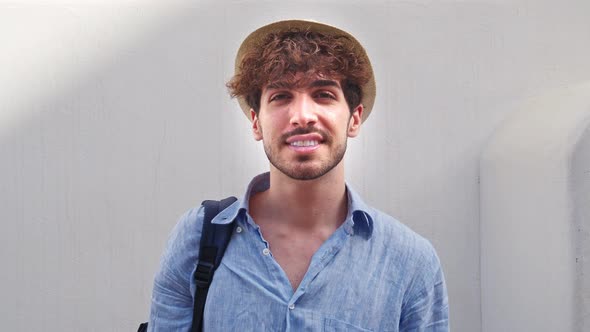 Portrait of a Young Italian Man with a Straw Hat Looking at the Camera