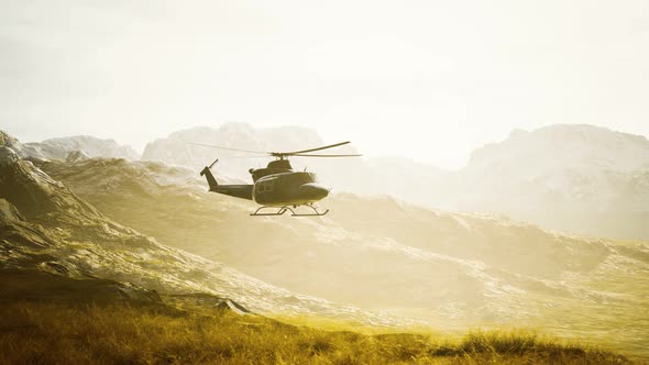 Slow Motion Vietnam War Era Helicopter in Mountains alt