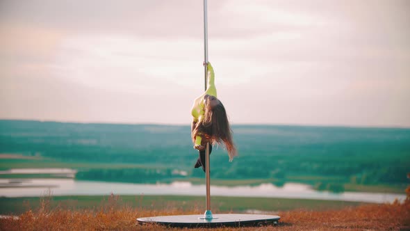 Woman in Yellow Swimsuit Dancing By the Pole - Rotating on the Pole