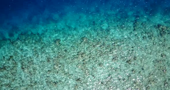 Wide angle flying travel shot of a summer white paradise sand beach and aqua blue ocean background i