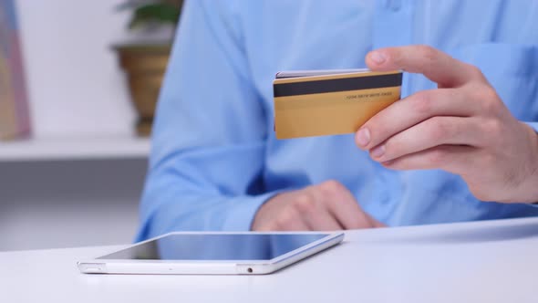 Man Chooses a Credit Card To Make Purchases Online. Close Up