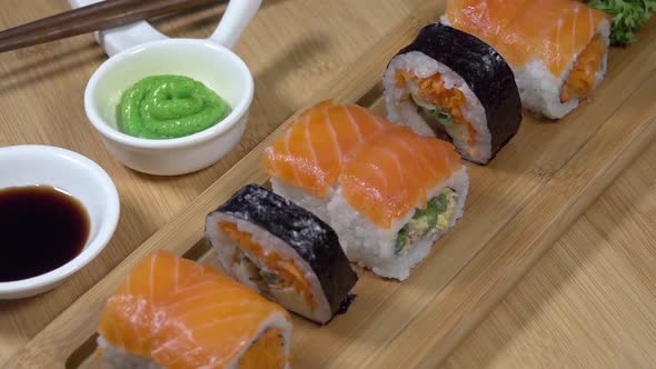 Top Down View Of Sushi Rotating on Bamboo Board