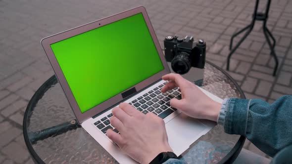 The Student Write Text on a Laptop with a Green Screen