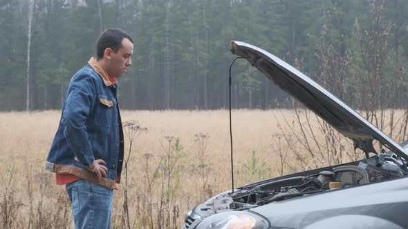 Car Accident. Young Man Looking at at Engine.