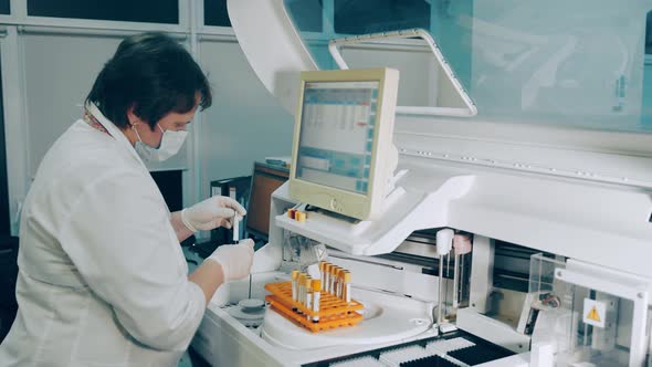Microbiologist Conducts Research in the Laboratory. The Researcher Performs a Biochemical Analysis