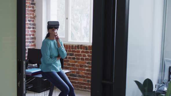 Woman using VR headset at office