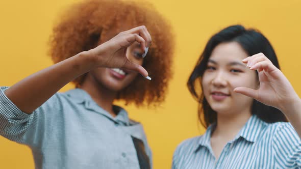 Multiracian Homosexual Relationship Concept. African American Black and Asian Woman Making Hearts