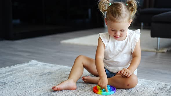 Cute Little Girls Playing with Enthusiasm Pop It Sensory Toy Circle Form