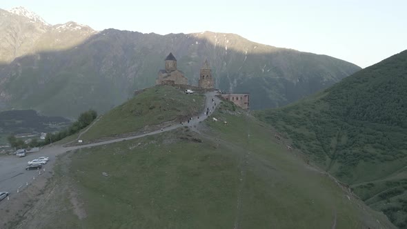 Stepantsminda, Georgia - May 8 2021: Aerial view of Gergeti Trinity Church, Tsminda Sameba. Kazbegi