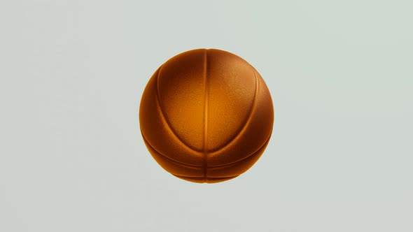 Golden basketball ball rotates on white background.