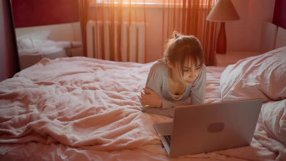 Woman Freelancer or Student Lying Bed Using Laptop During Quarantine