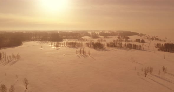 Aerial View of Cold Winter Landscape Arctic Field Trees Covered with Frost Snow Ice River and Sun