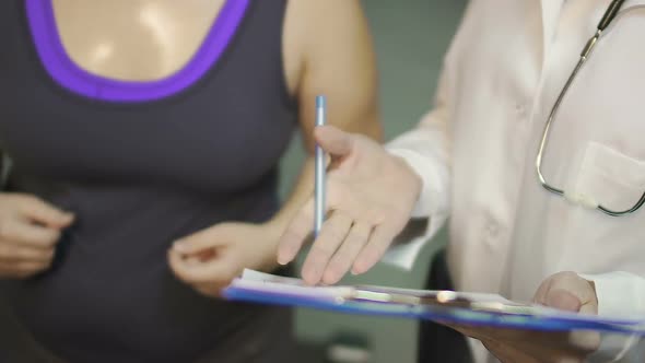 Nurse Showing Test Result on Paper to Fat Girl Running on Treadmill, Health Care