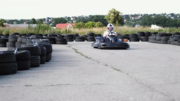 Male Racer in Protective Helmet Racing on the Go-kart Track Outdoors