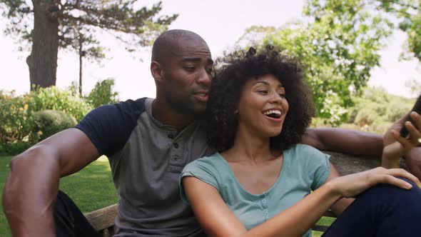 Happy mixed race couple enjoying in the garden during a sunny day