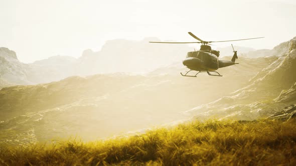 Slow Motion Vietnam War Era Helicopter in Mountains