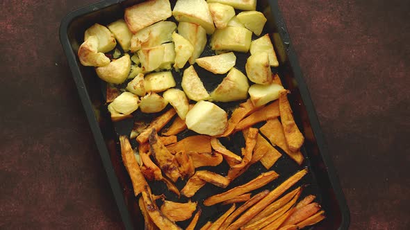 Baked Vegetables. Potatoes, Carrot and Sweet Potatoes on Metal Tray.