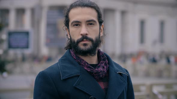 Proud confident handsome latin man in the street,looking at camera