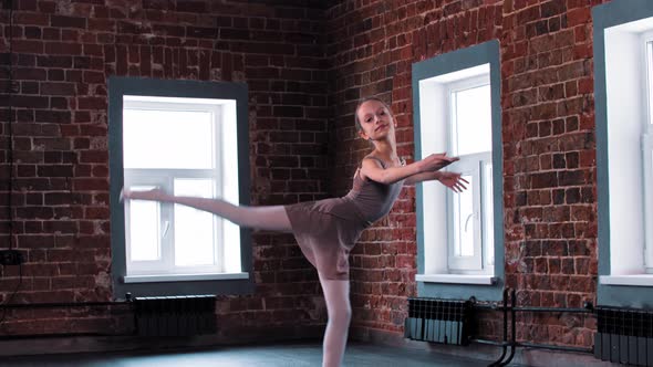 A Ballerina Girl Training Her Dancing in the Light Studio