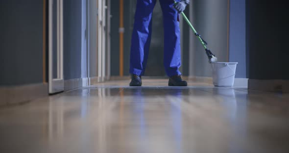Janitor Cleaning a Corridor