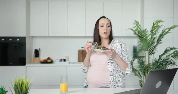 Pregnant Woman Presses Key on Laptop Watch Video in Kitchen