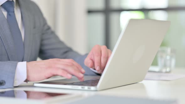 Close Up of Businessman Working on Laptop