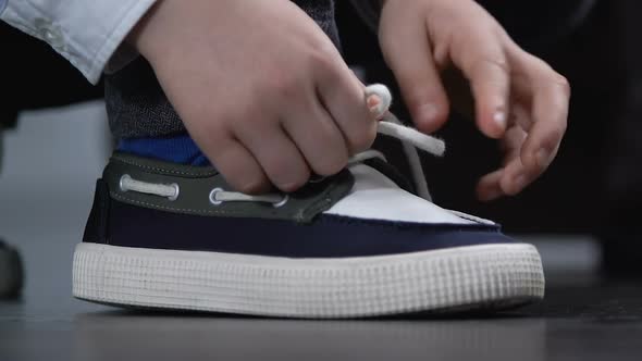 School Boy Tying Shoelaces by Knot, Stylish Teenage Sneakers, Comfortable Shoes