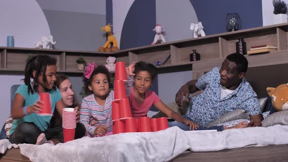 Mixed Race Family Playing on Bed During Quarantine