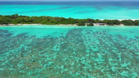 Luxury aerial island view of a sandy white paradise beach and blue ocean background in colourful 4K