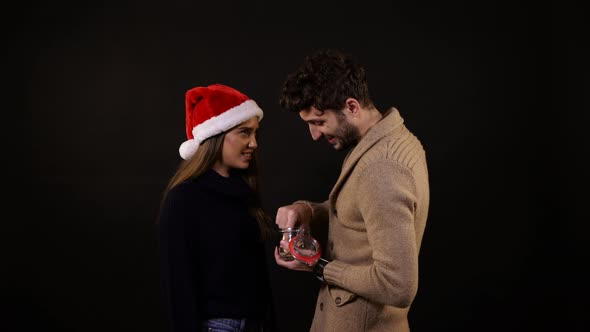 A man feeding woman with cookies