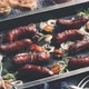 Tasty Grilled Homemade Rosemary Sausages Placed on Iron Frying Tray Over Rustic Dark Stone Table - VideoHive Item for Sale